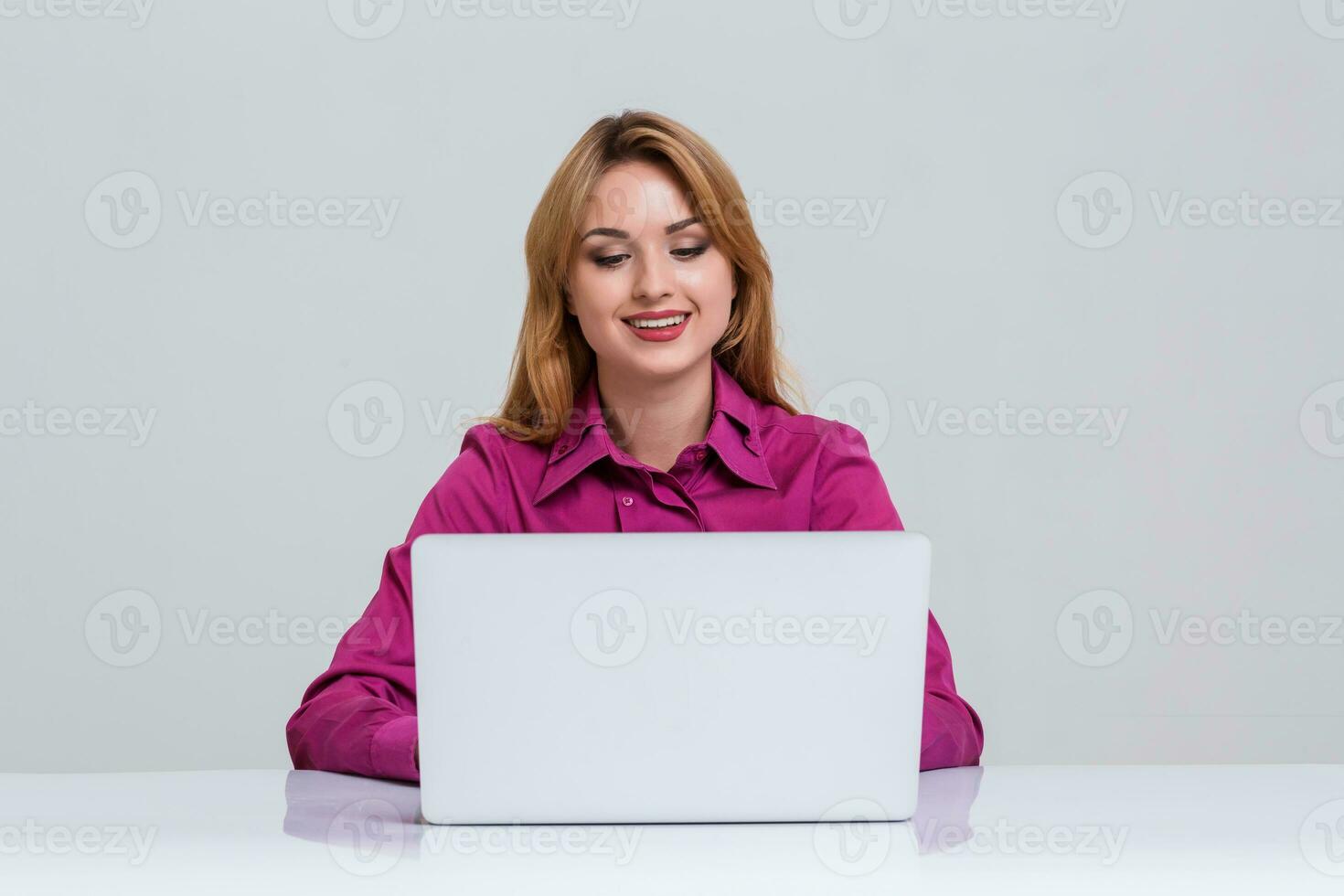 young woman sitting in the table and using laptop photo