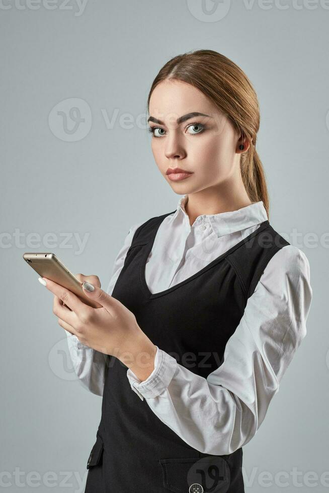 Pretty young business woman using mobile phone indoor photo