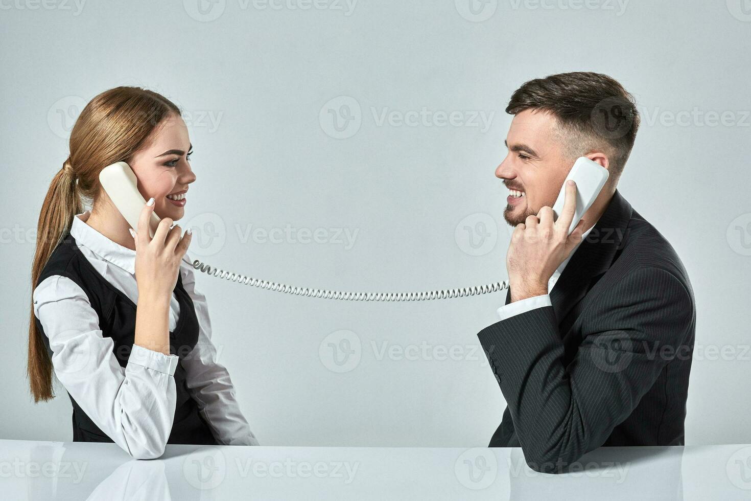 picture of man and woman with telephone at the table photo