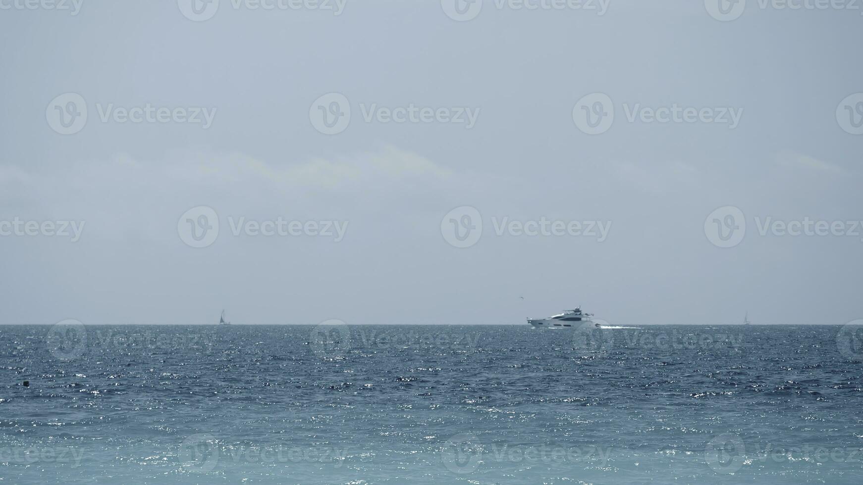 Beautiful calm sea and blue cloudy sky. Action. Amazing horizon and the endless sea water. photo
