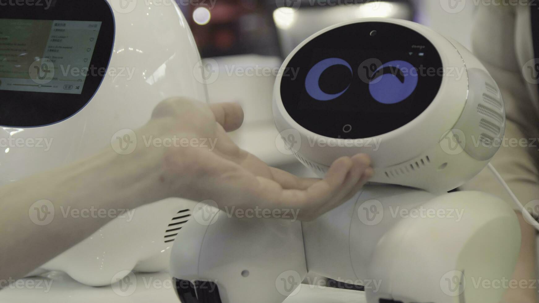 Hand of man touches the robot. Robot is happy with the touch of a human. Technology concept photo