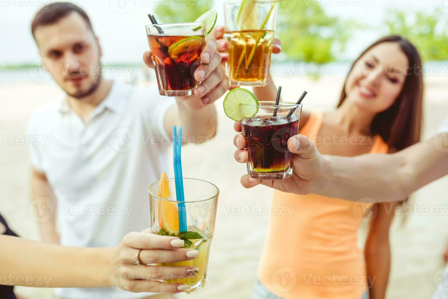 Friends having fun at the bar outdoors, drinking cocktails. photo