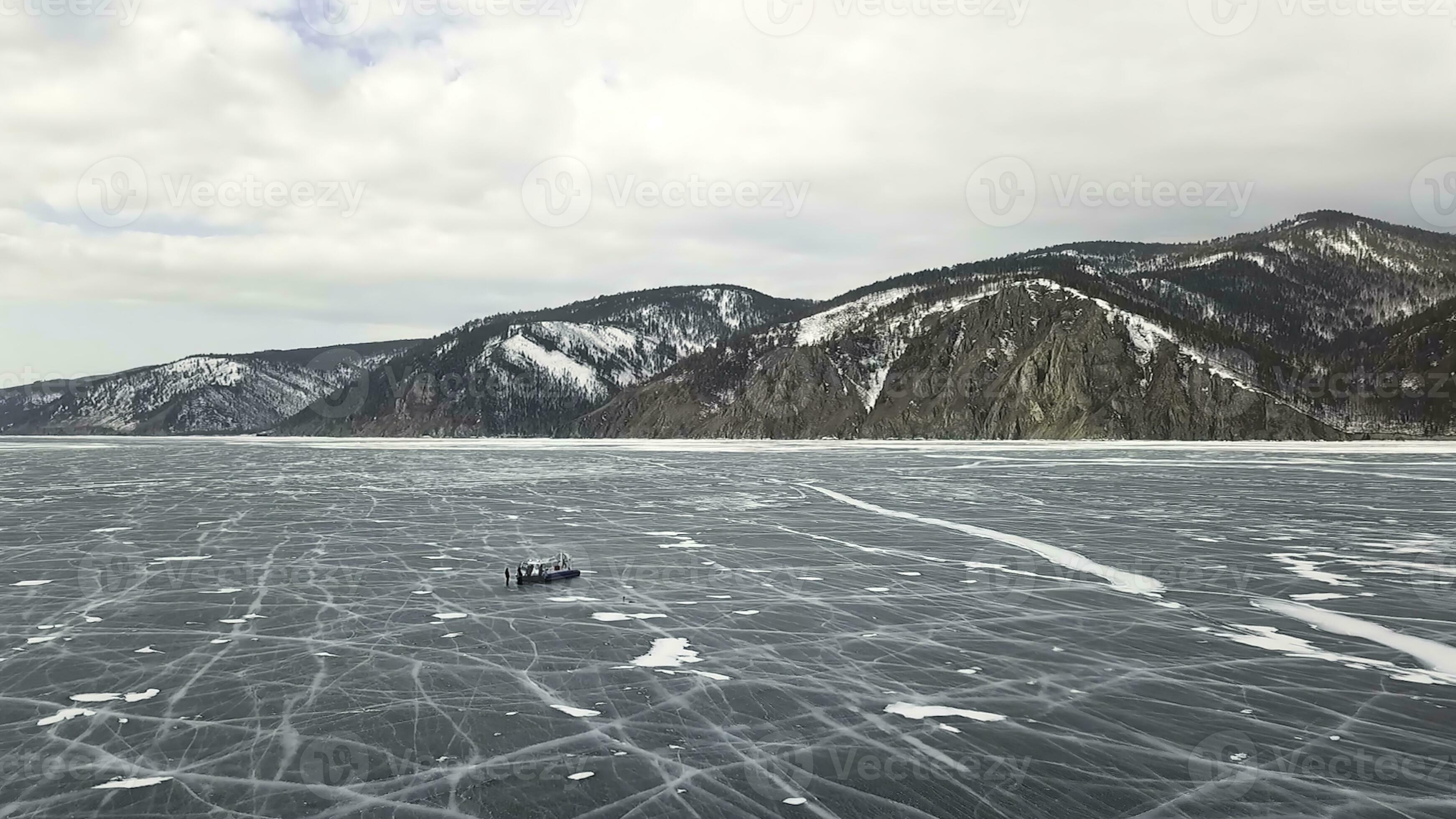 Winter Baikal Lake with tourists on ice having fun. Clip. Aerial view ...