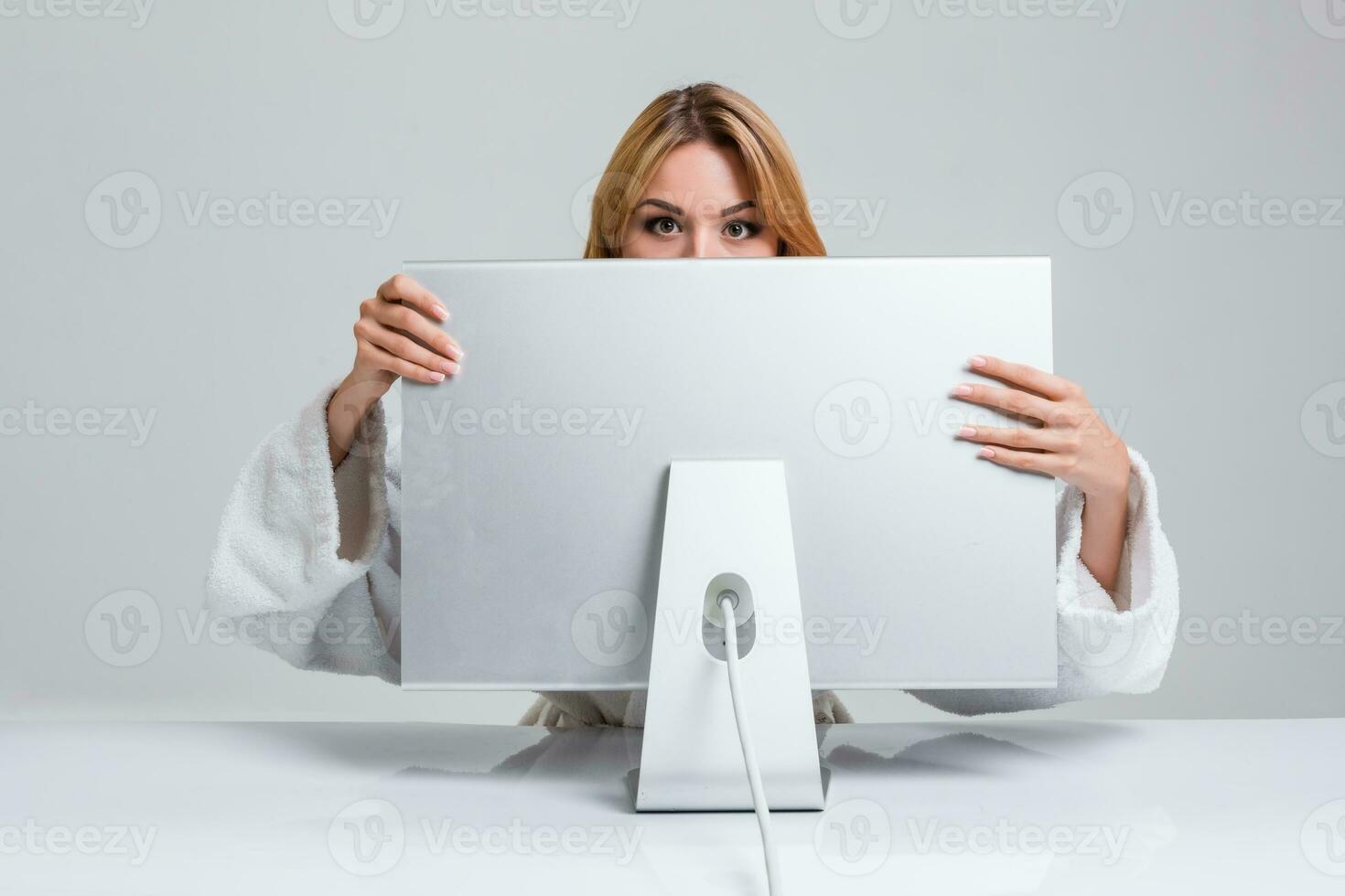 young woman sitting in the table and using computer photo