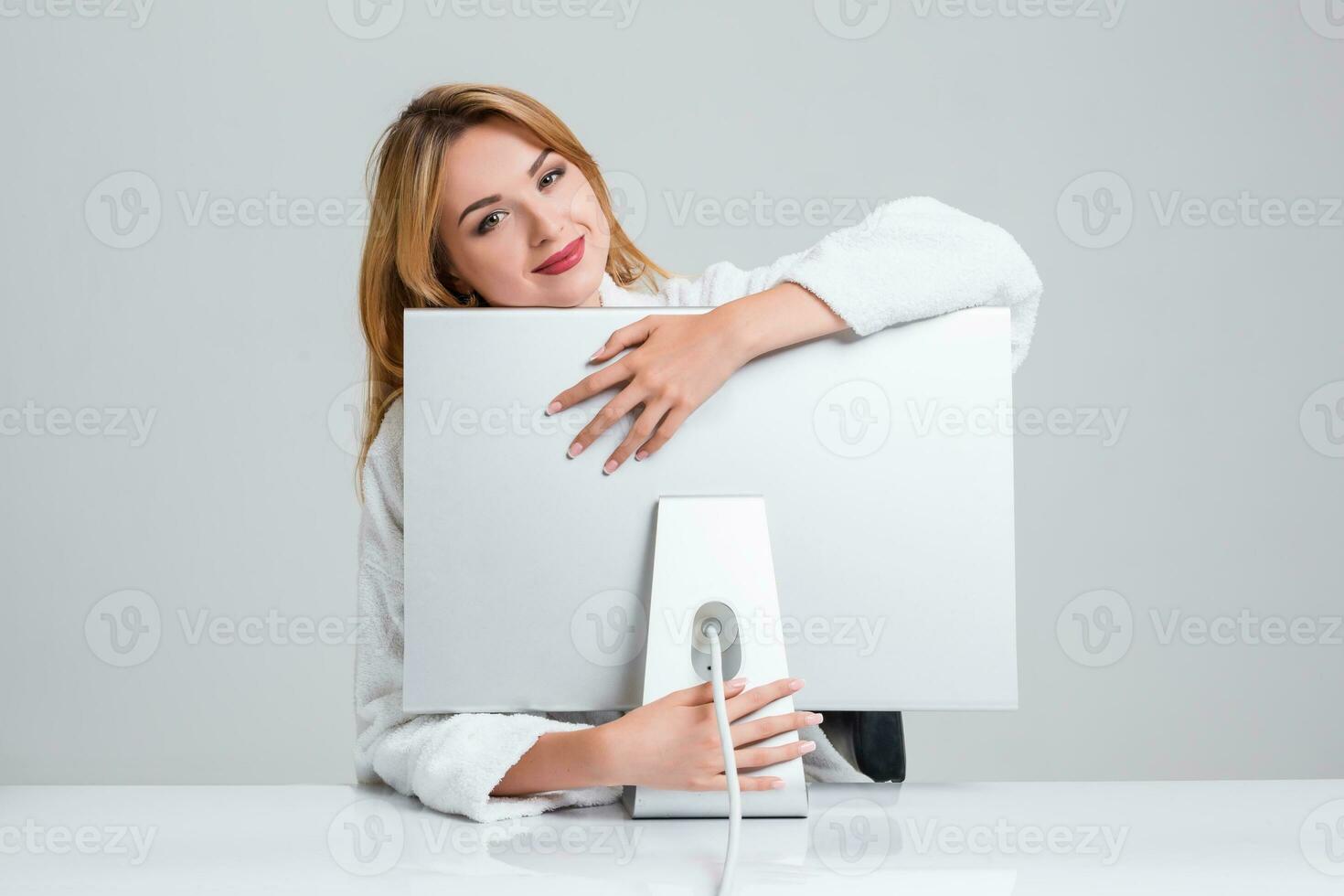 young woman sitting in the table and using computer photo