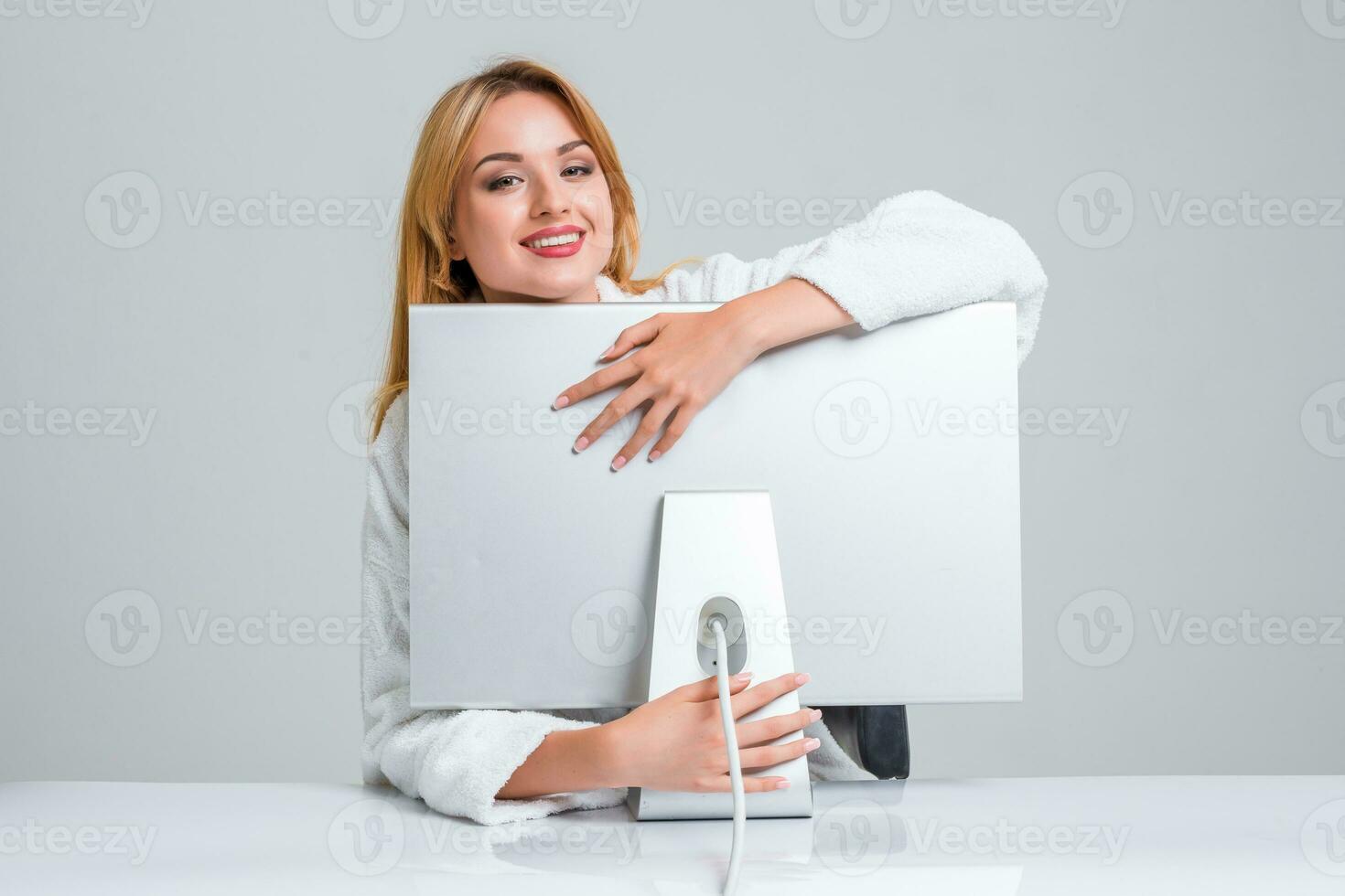 young woman sitting in the table and using computer photo