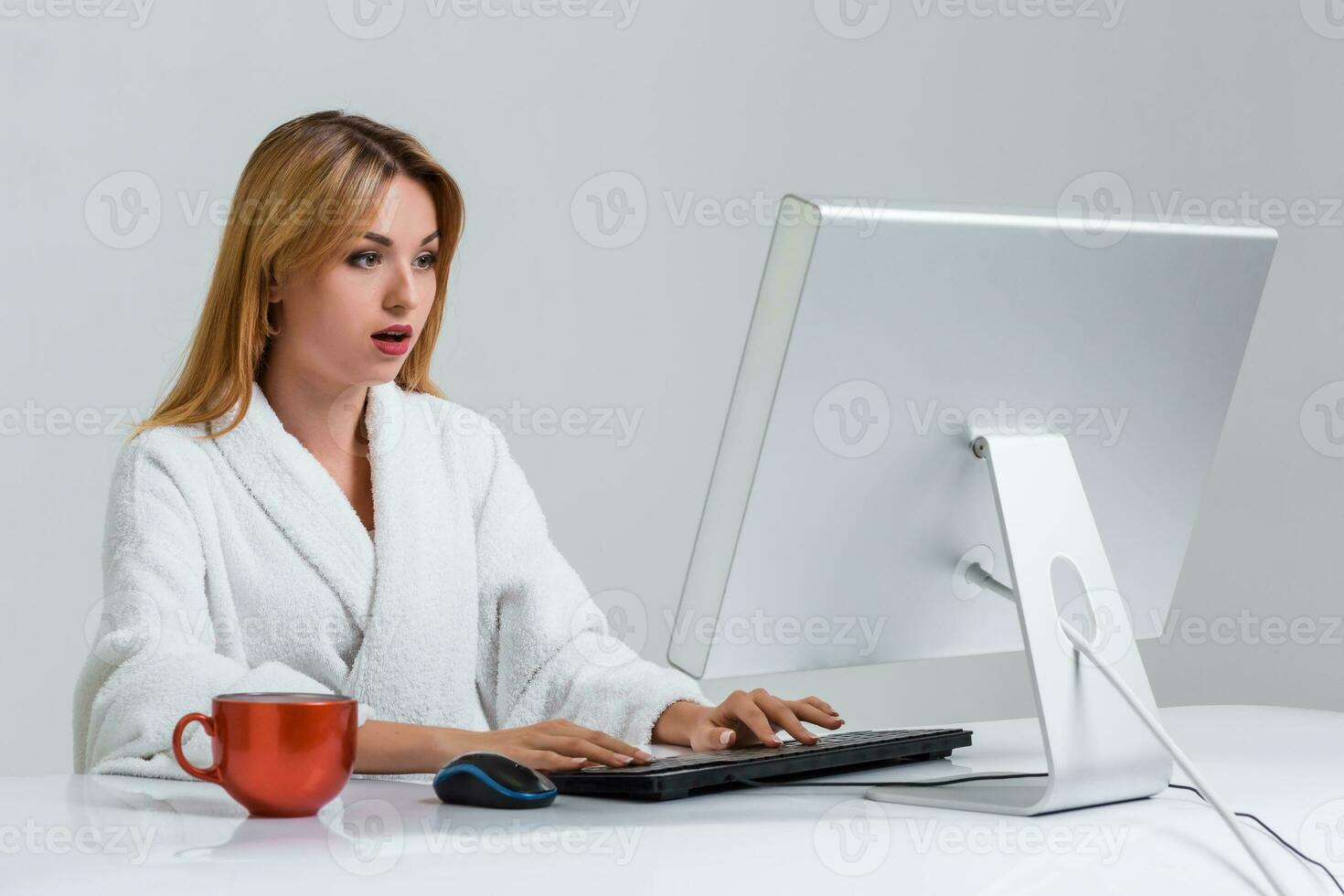 young woman sitting in the table and using computer photo