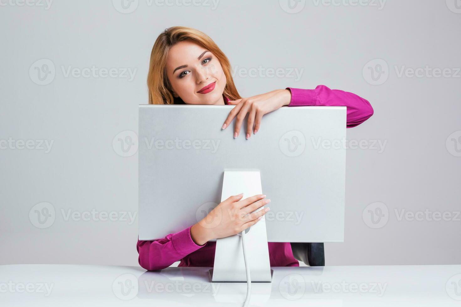 young woman sitting in the table and using computer photo