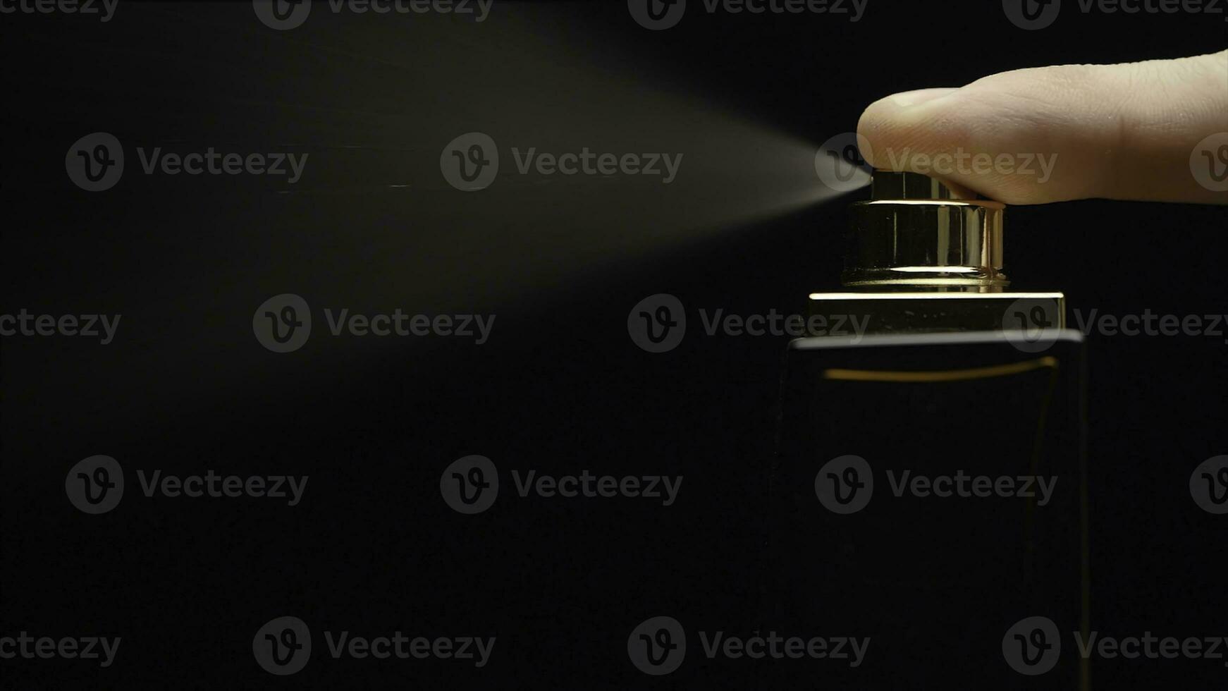 Cinemagraph - Close up of a spray bottle drops on black background. Male perfume bottle on a dark background. close up of a spray bottle drops on black background photo