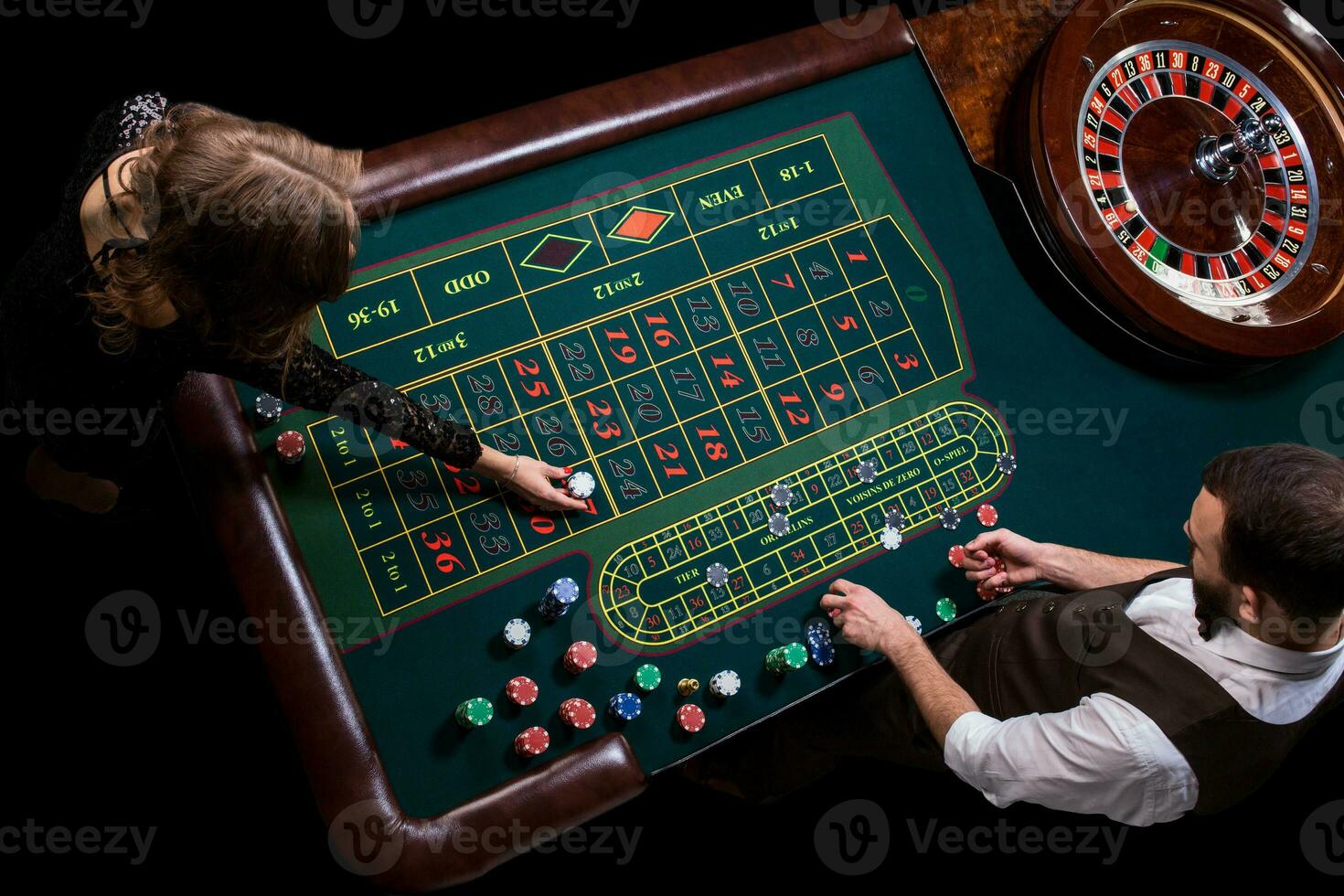 Croupier and woman player at a table in a casino. Picture of a c photo