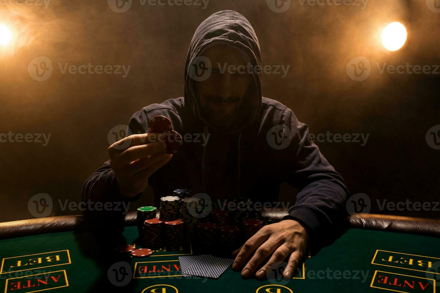 Portrait of a professional poker player sitting at poker table photo