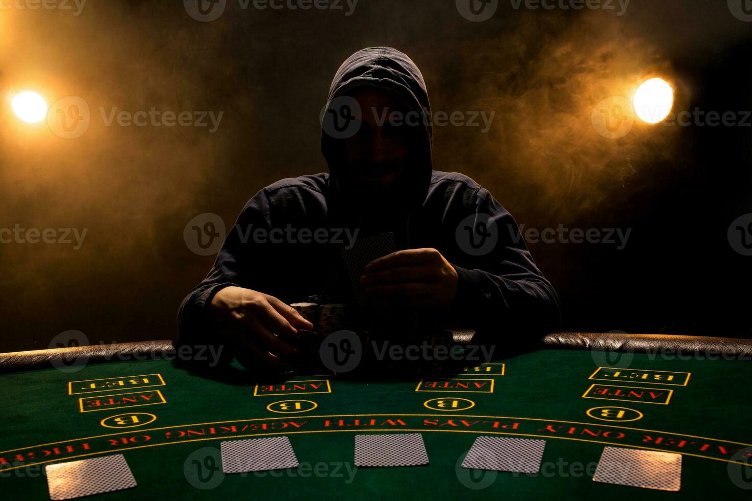 Portrait of a professional poker player sitting at poker table photo