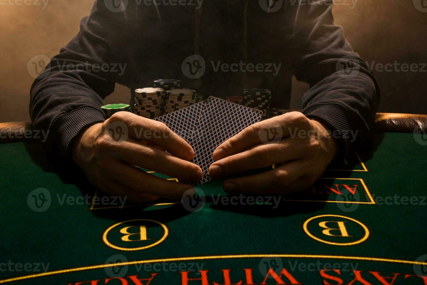 Man's hand with playing cards close up. Casino card game chips. Put on the table playing cards. Poker chips on the table. photo