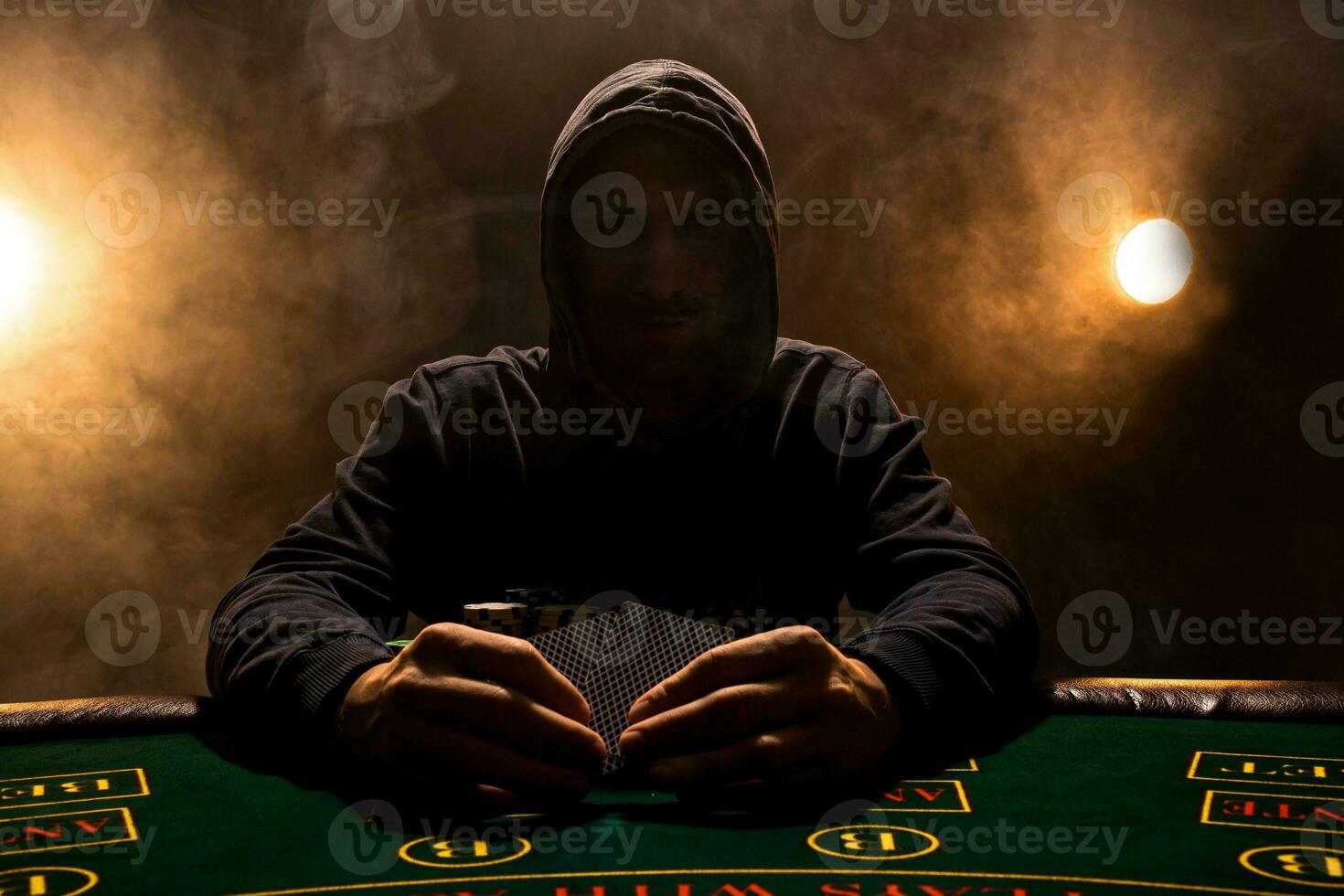 Portrait of a professional poker player sitting at pokers table photo