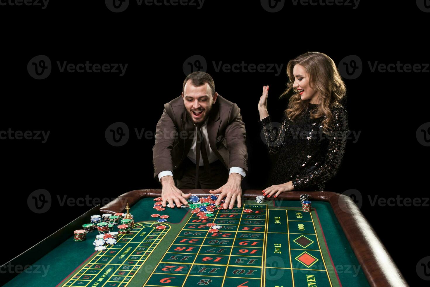 Man with woman playing roulette at the casino. Addiction to the photo