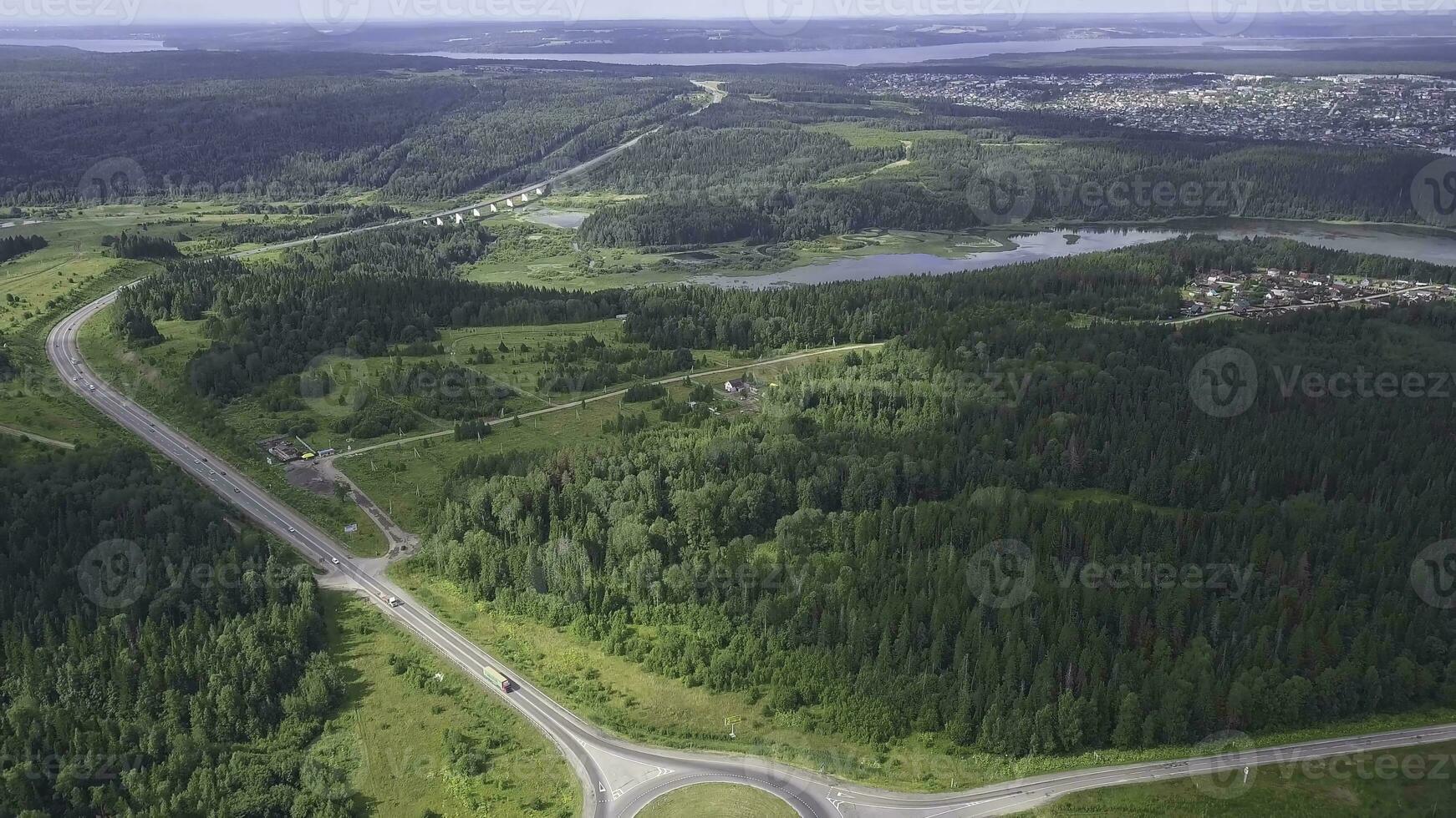 Top view of rural roundabout. Clip. Traffic on roundabout rural road in wooded area photo