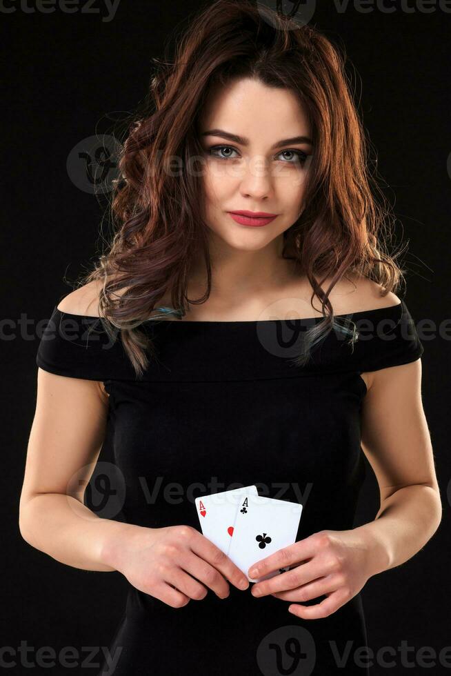 Young woman playing in the gambling on black background photo