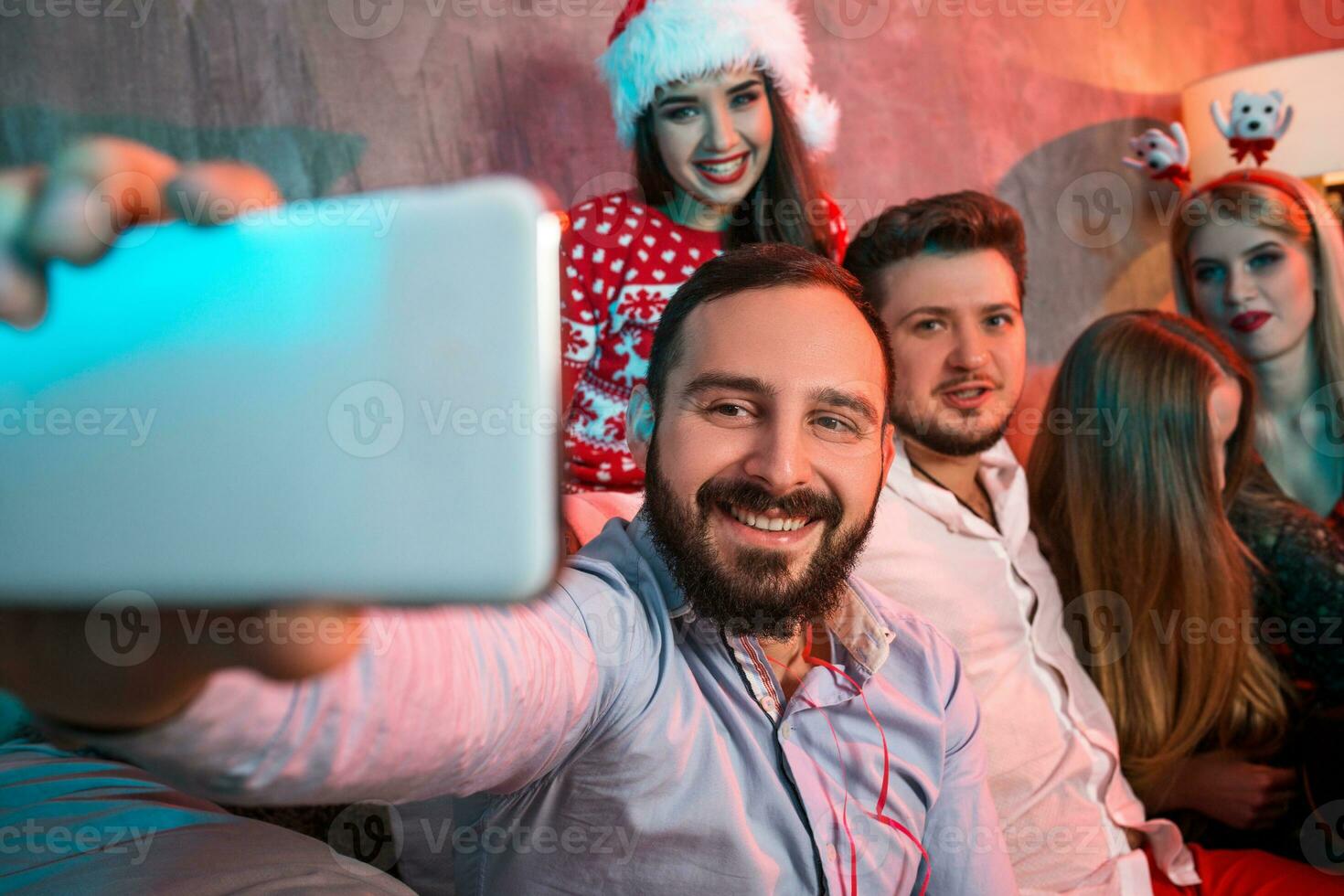 Friends making selfie while celebrating Christmas or New Year eve at home photo