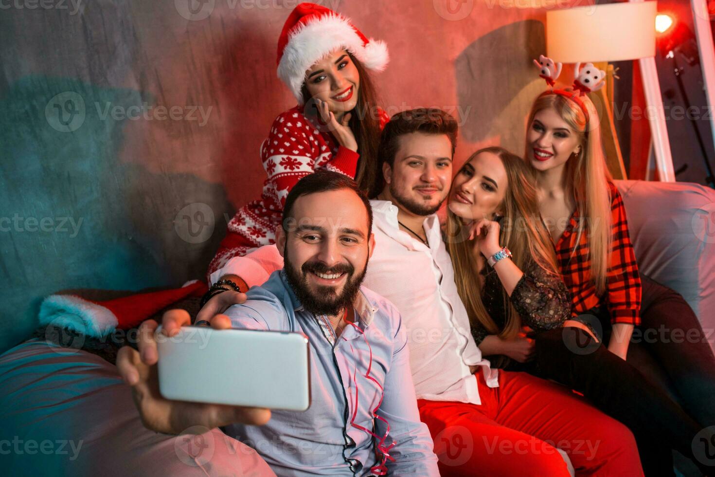 Friends making selfie while celebrating Christmas or New Year eve at home photo