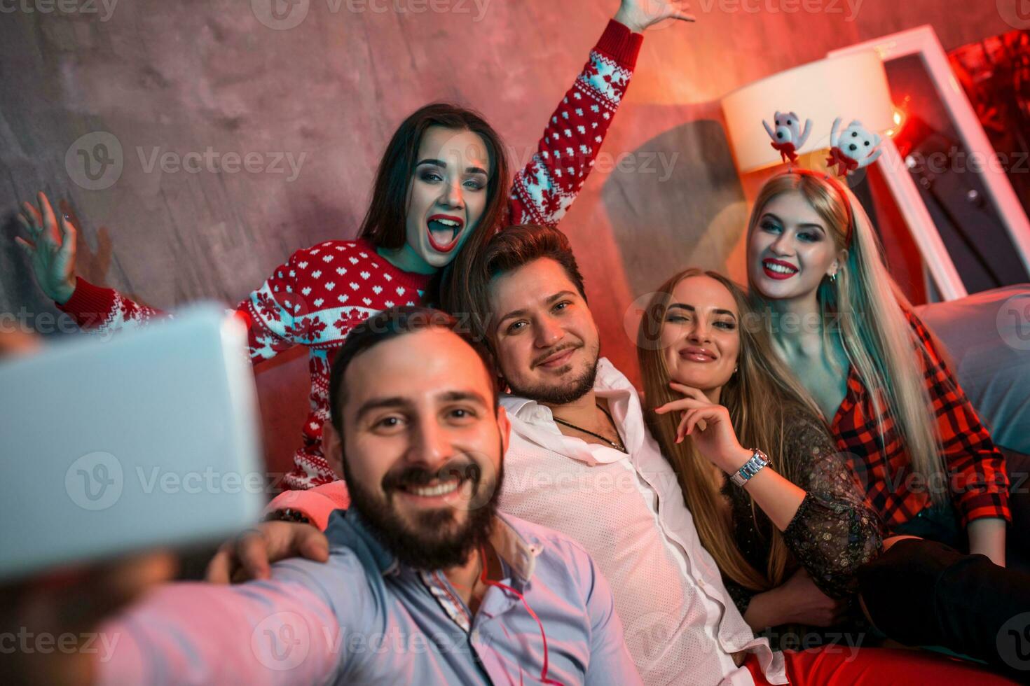 Friends making selfie while celebrating Christmas or New Year eve at home photo