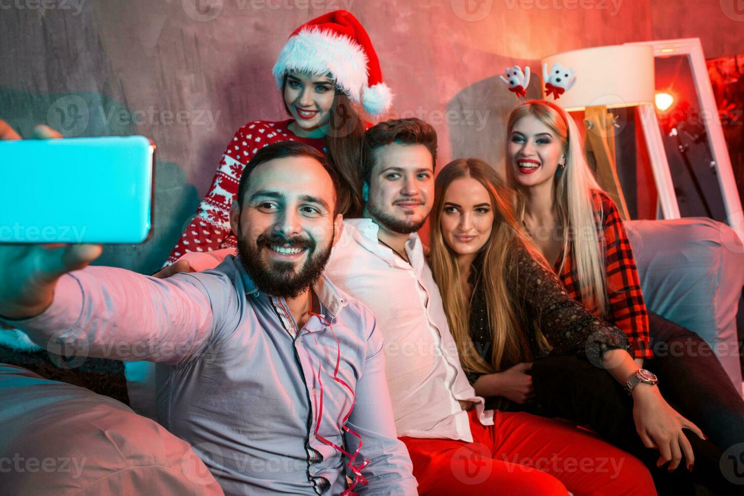 Friends making selfie while celebrating Christmas or New Year eve at home photo