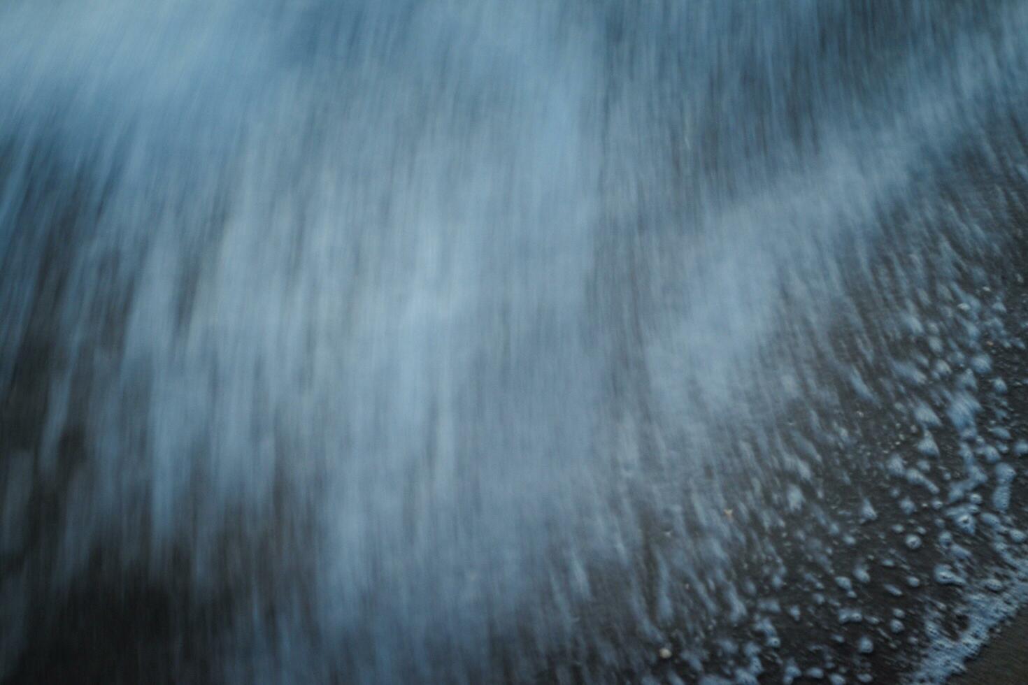 AI generated Abstract sand beach from above with light blue Close-up soft wave of the sea on the sandy beach photo