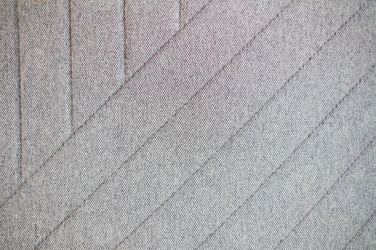 Grey herringbone tweed pattern, interior material background.  Fabric texture diagonal weave of natural cotton or linen textile material. Decorative fabric for curtain, furniture, walls, clothes photo