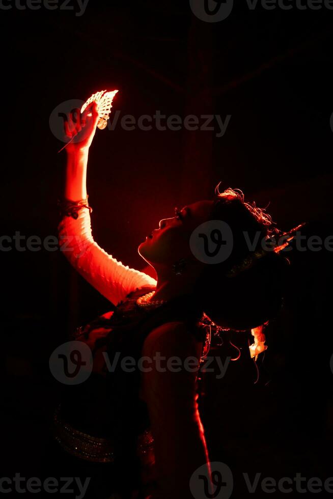 a woman holding gold jewelry with trembling hands and full of worries photo