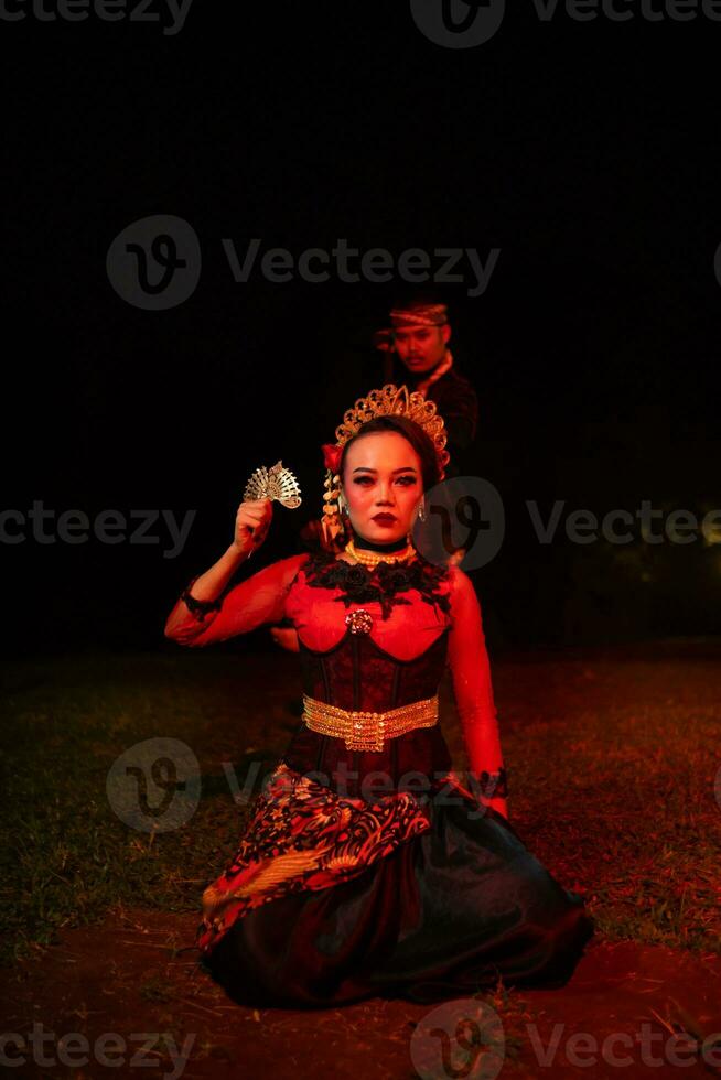 un grupo de hembra bailarines con caras lleno de tristeza sentado solo en el medio de un campo foto