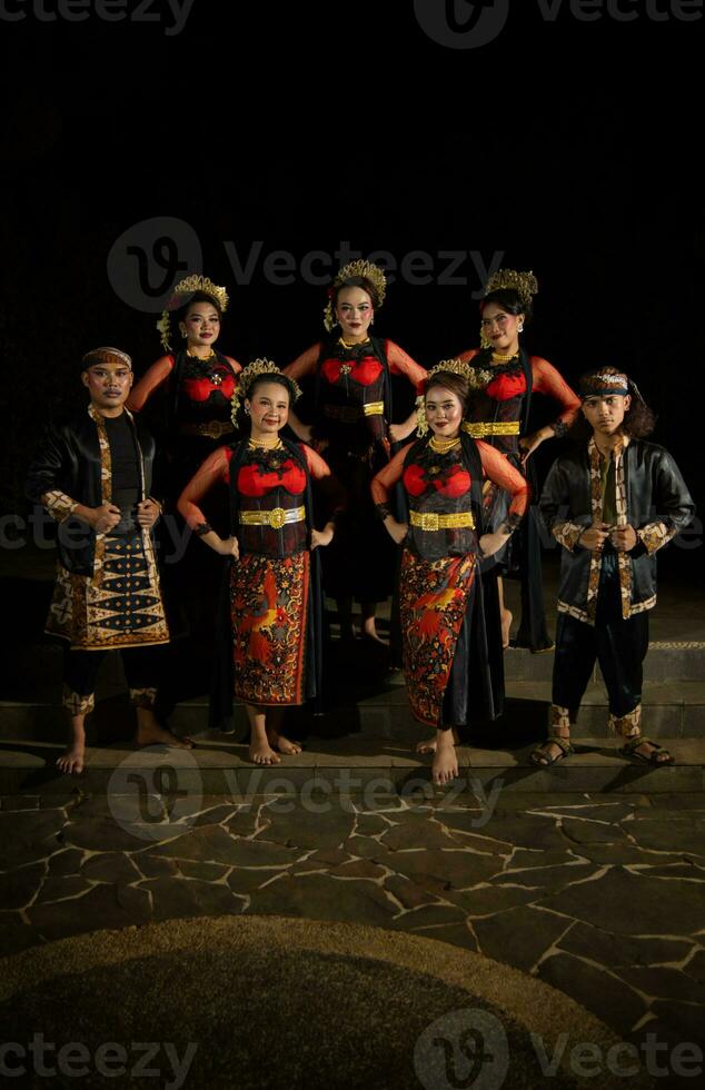 a group of dancers standing very proud and happy after finishing performing on stage photo