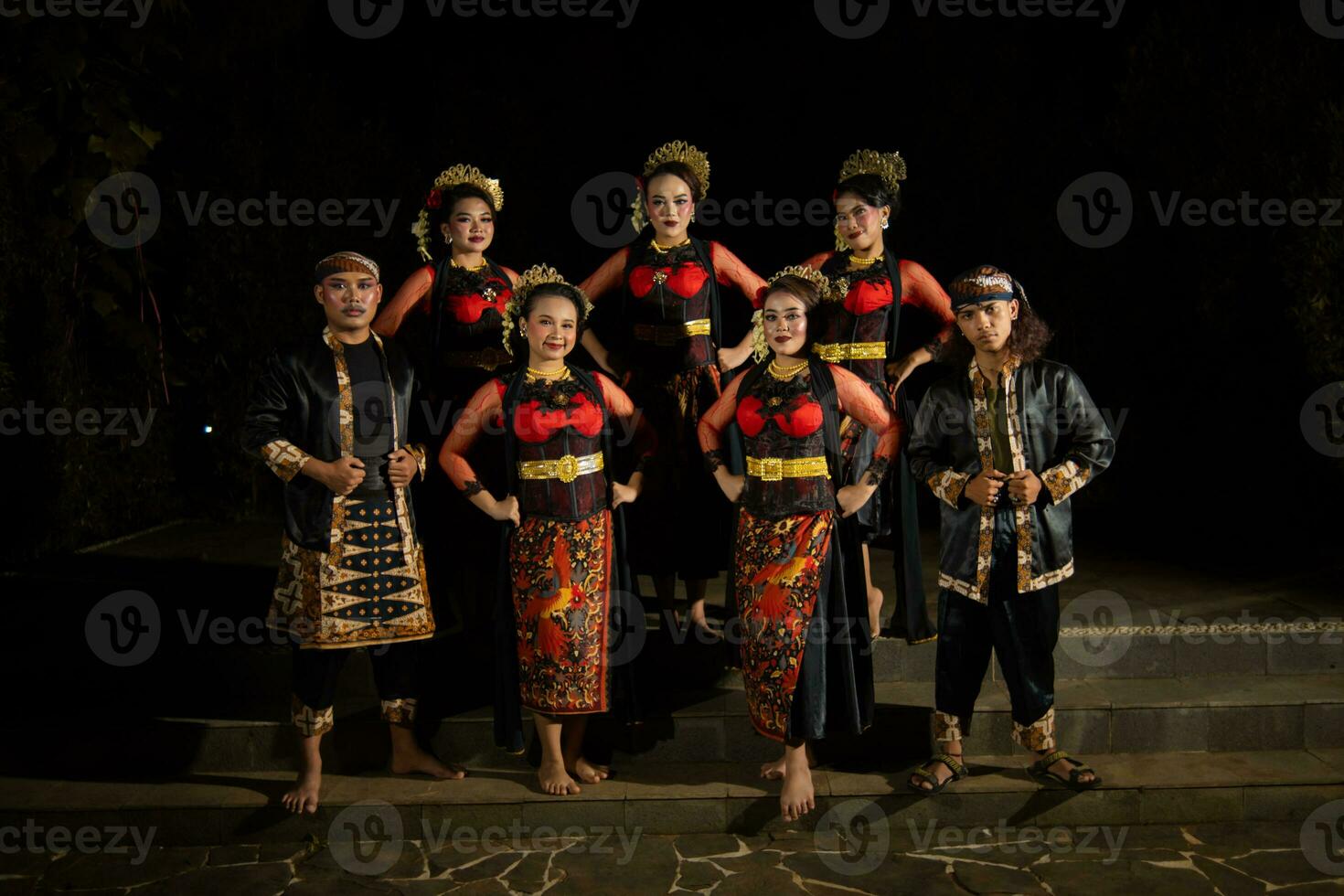 a group of dancers standing very proud and happy after finishing performing on stage photo