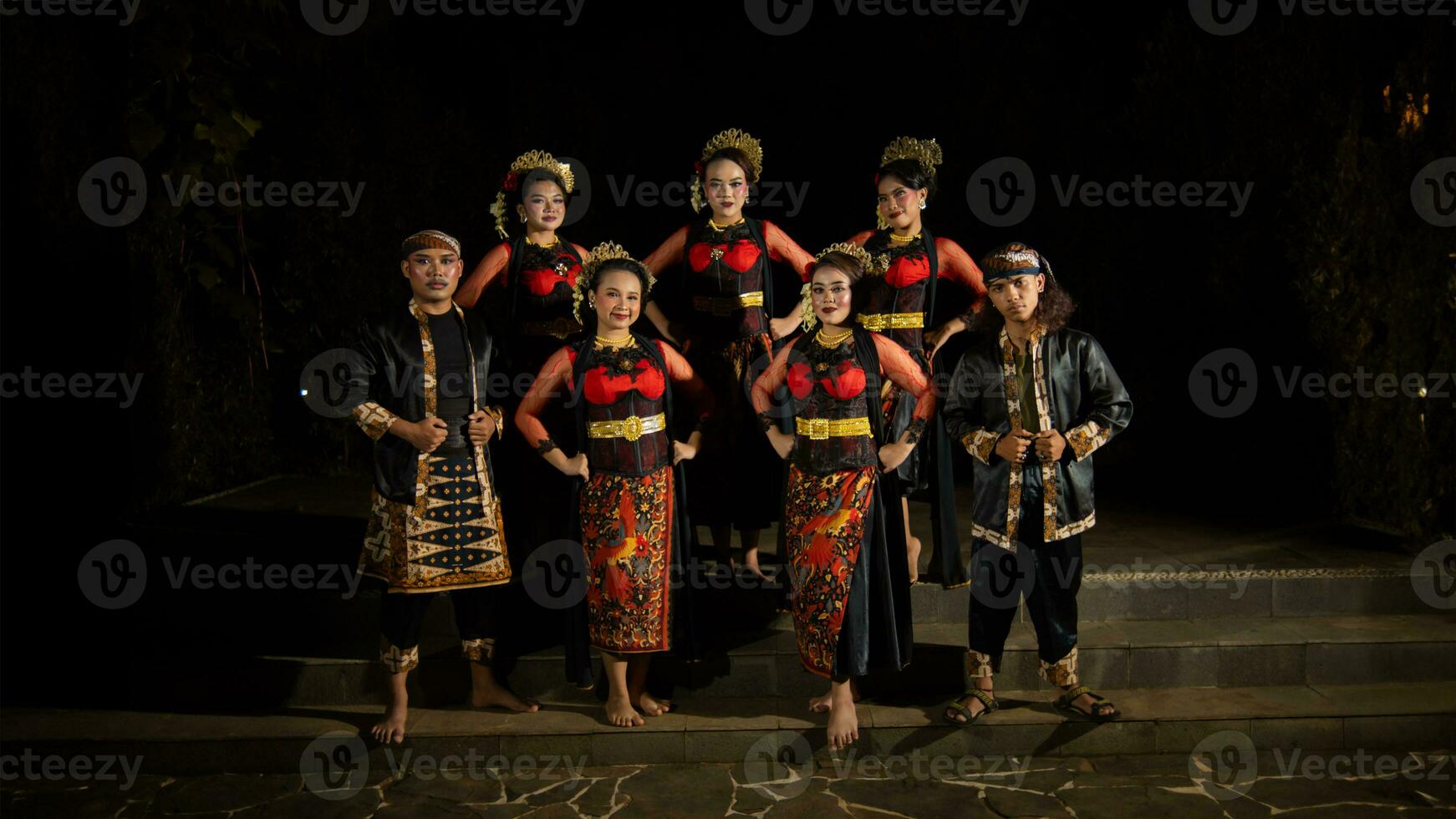 a group of dancers standing very proud and happy after finishing performing on stage photo