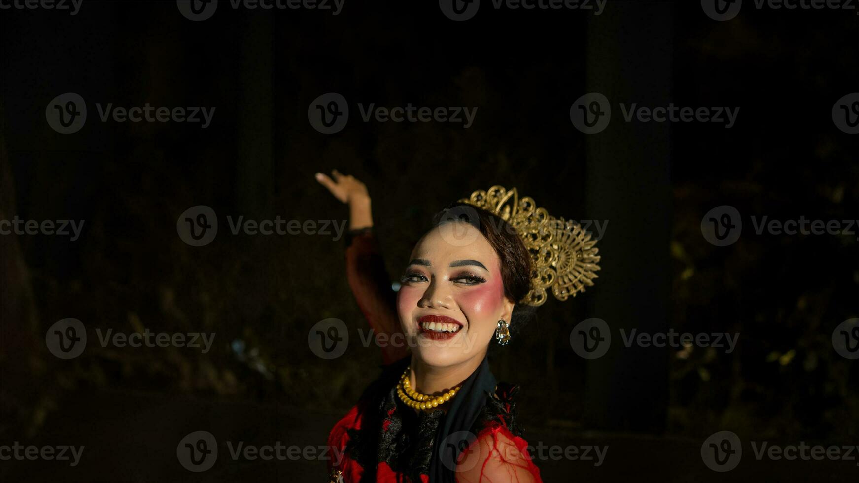 an Indonesian dancer with facial expressions that radiate beauty and happiness dances and captivates the audience photo