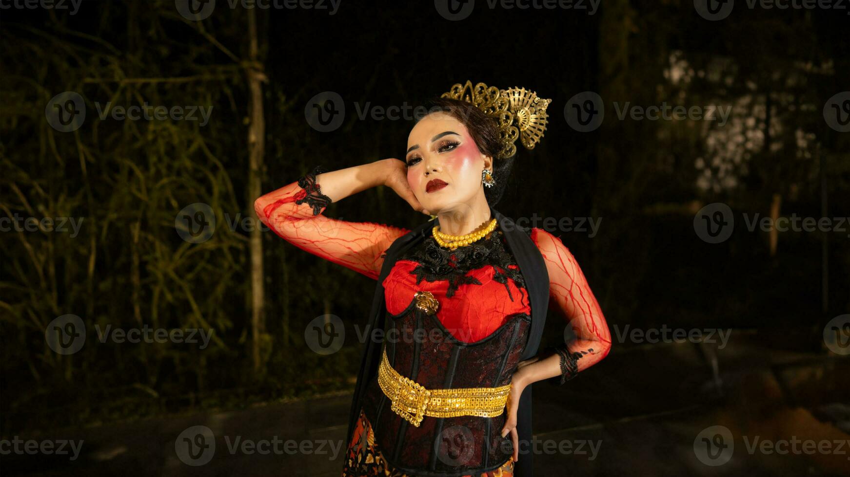 an Asian dancer poses very beautifully while standing in the castle photo
