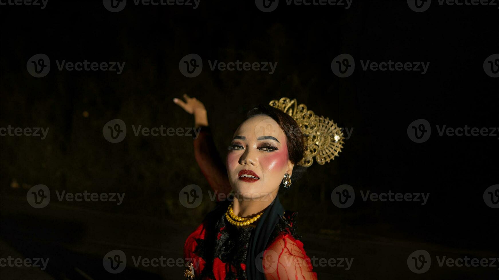 an Indonesian dancer with facial expressions that radiate beauty and happiness dances and captivates the audience photo