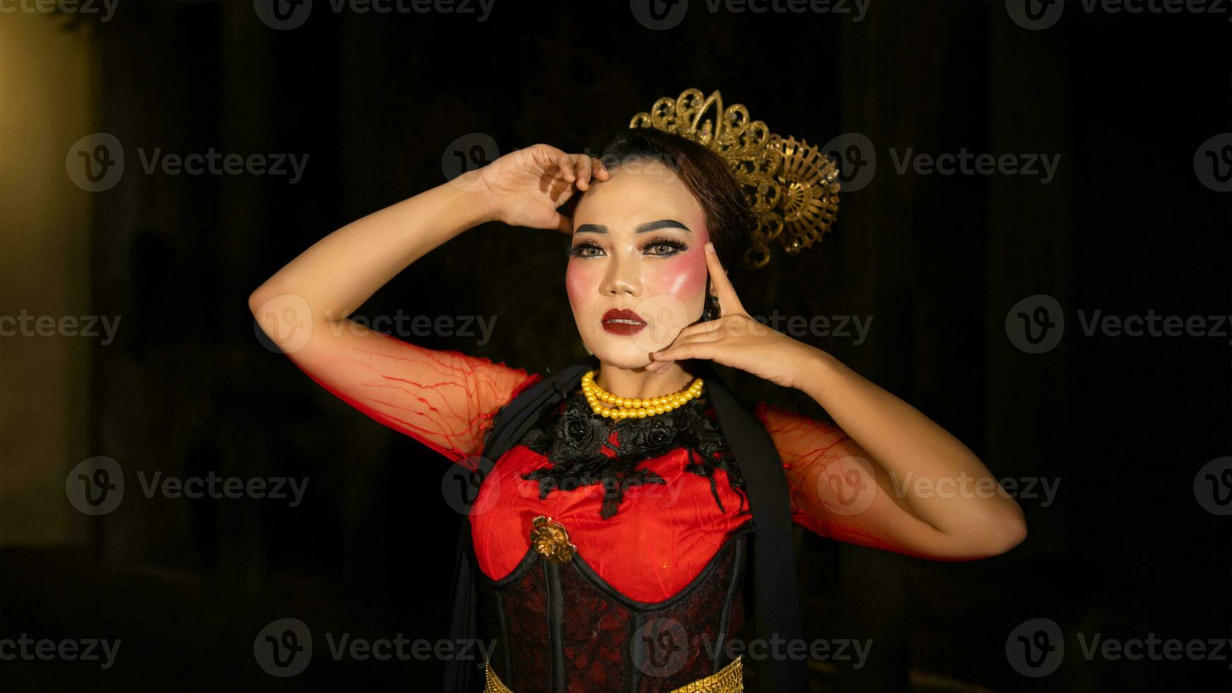 An Indonesian dancer becomes an ambassador of cultural beauty and elegance by dancing on stage photo