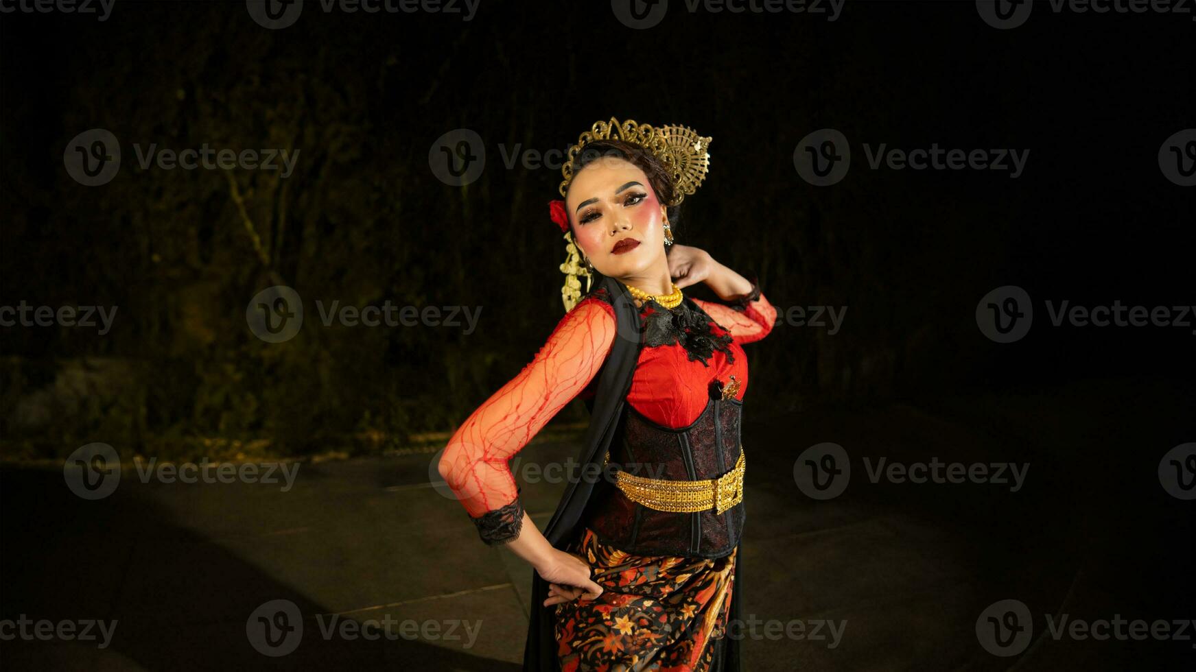 an Asian dancer poses very beautifully while standing in the castle photo
