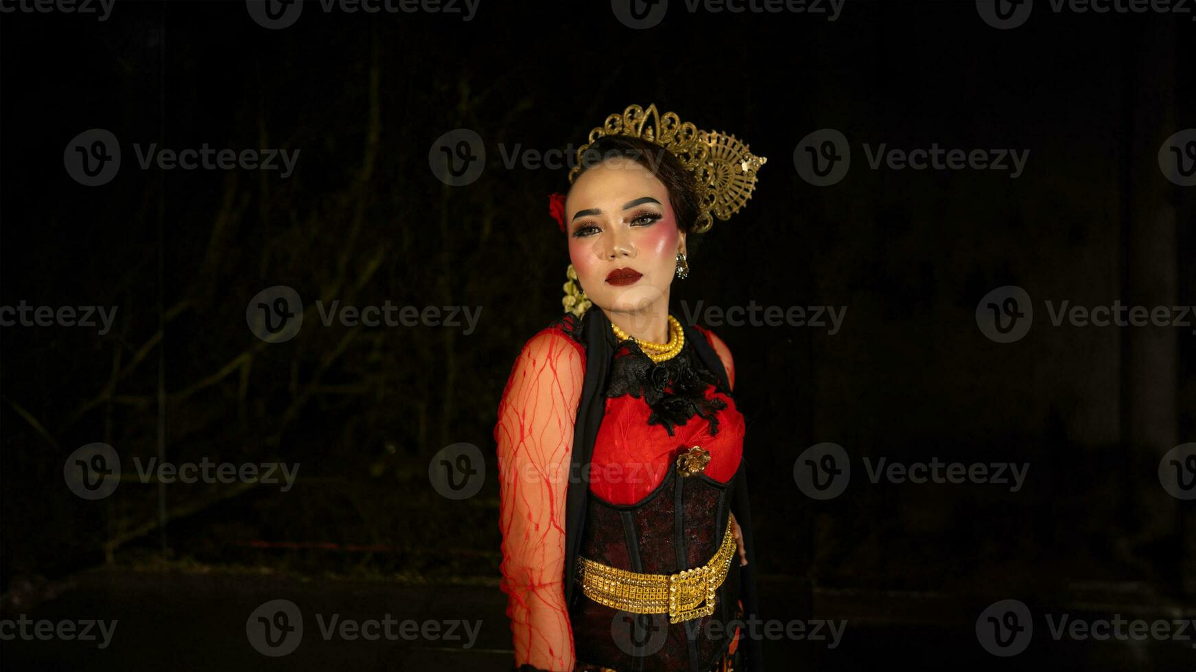 An Indonesian dancer becomes an ambassador of cultural beauty and elegance by dancing on stage photo