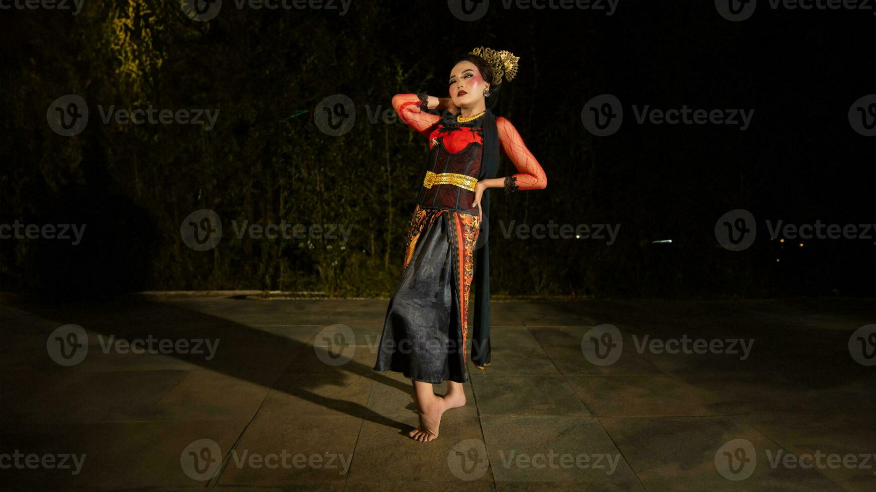 an Asian dancer poses very beautifully while standing in the castle photo