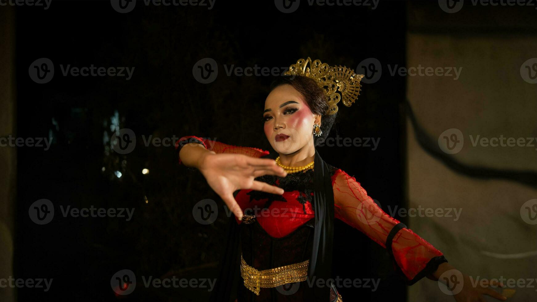 an Indonesian dancer seeks out and invites the audience to be carried away in a cultural performance photo