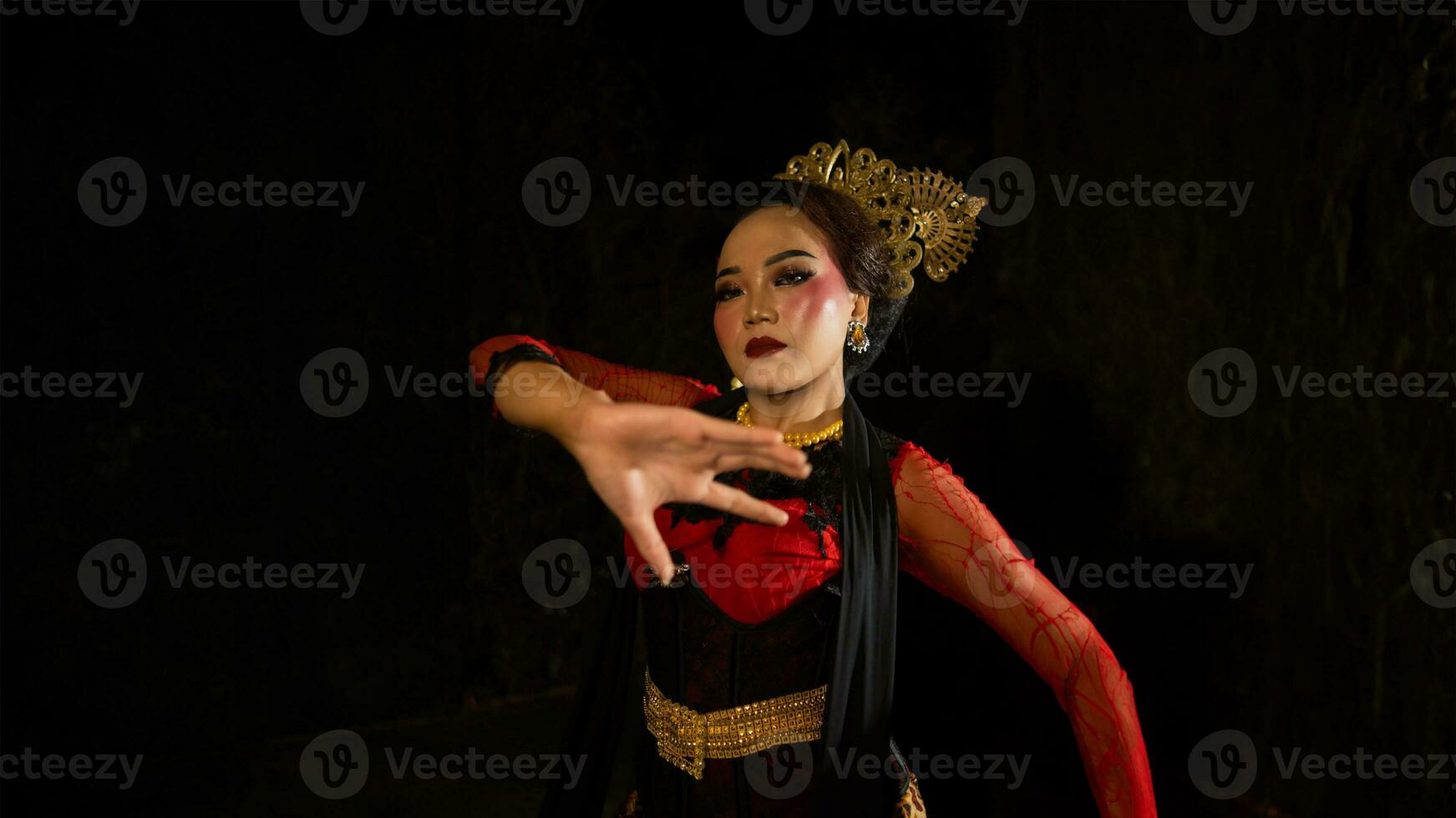 an Indonesian dancer seeks out and invites the audience to be carried away in a cultural performance photo