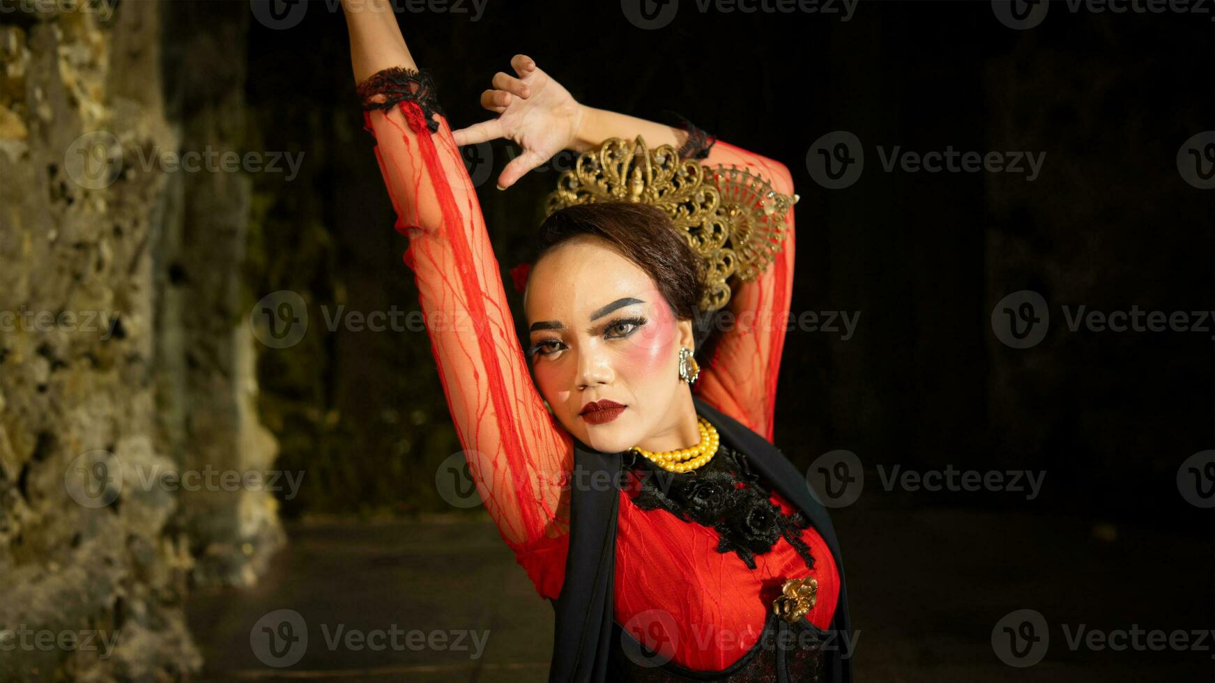 an Indonesian dancer seeks out and invites the audience to be carried away in a cultural performance photo