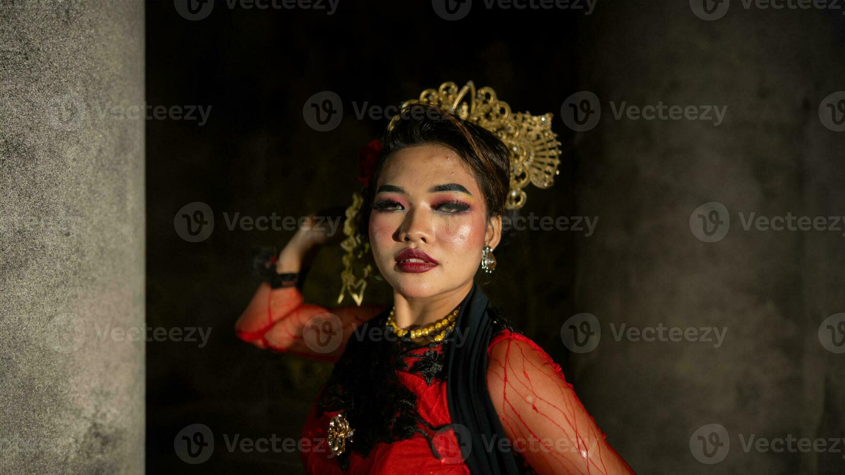 an Indonesian dancer with facial expressions that radiate beauty and happiness dances and captivates the audience photo