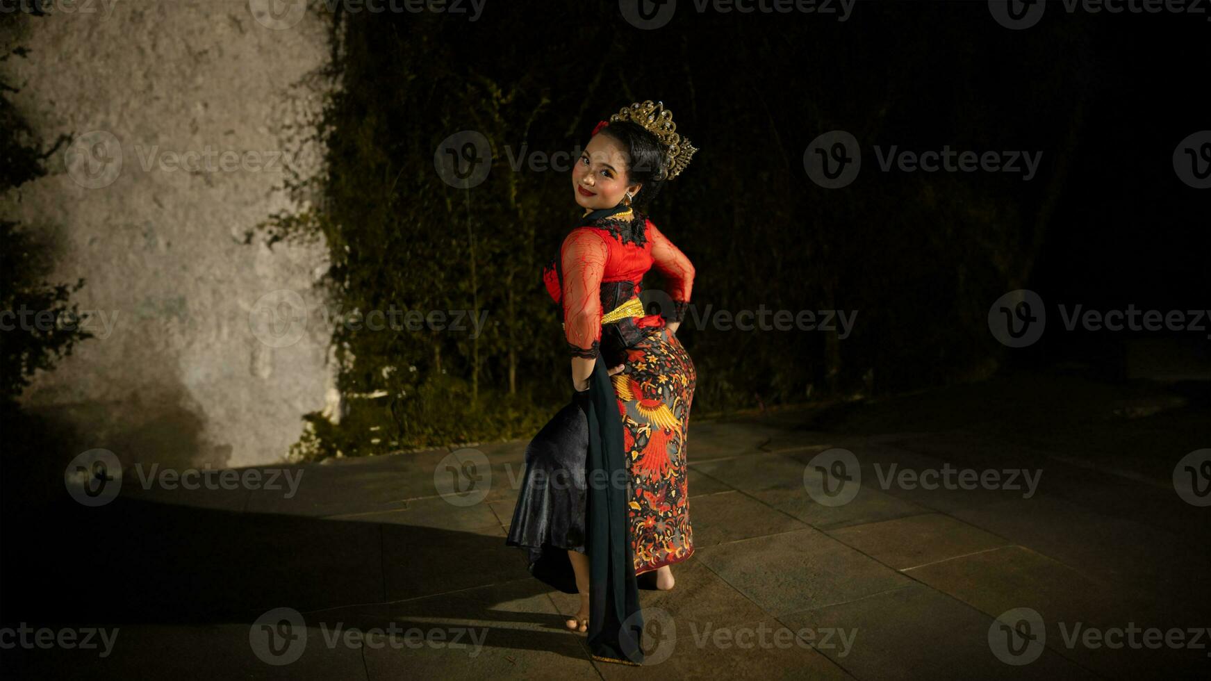 an Indonesian dancer looks full of enthusiasm and shows his courage to move and dance photo