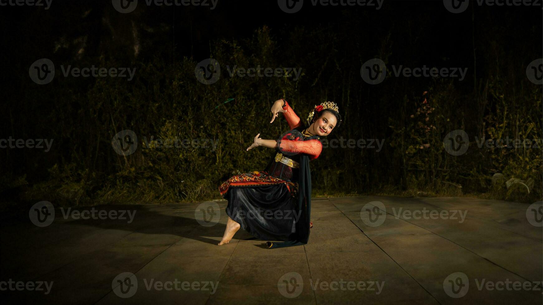 a Balinese dancer looks graceful when moving his hands and feet on stage very agilely photo