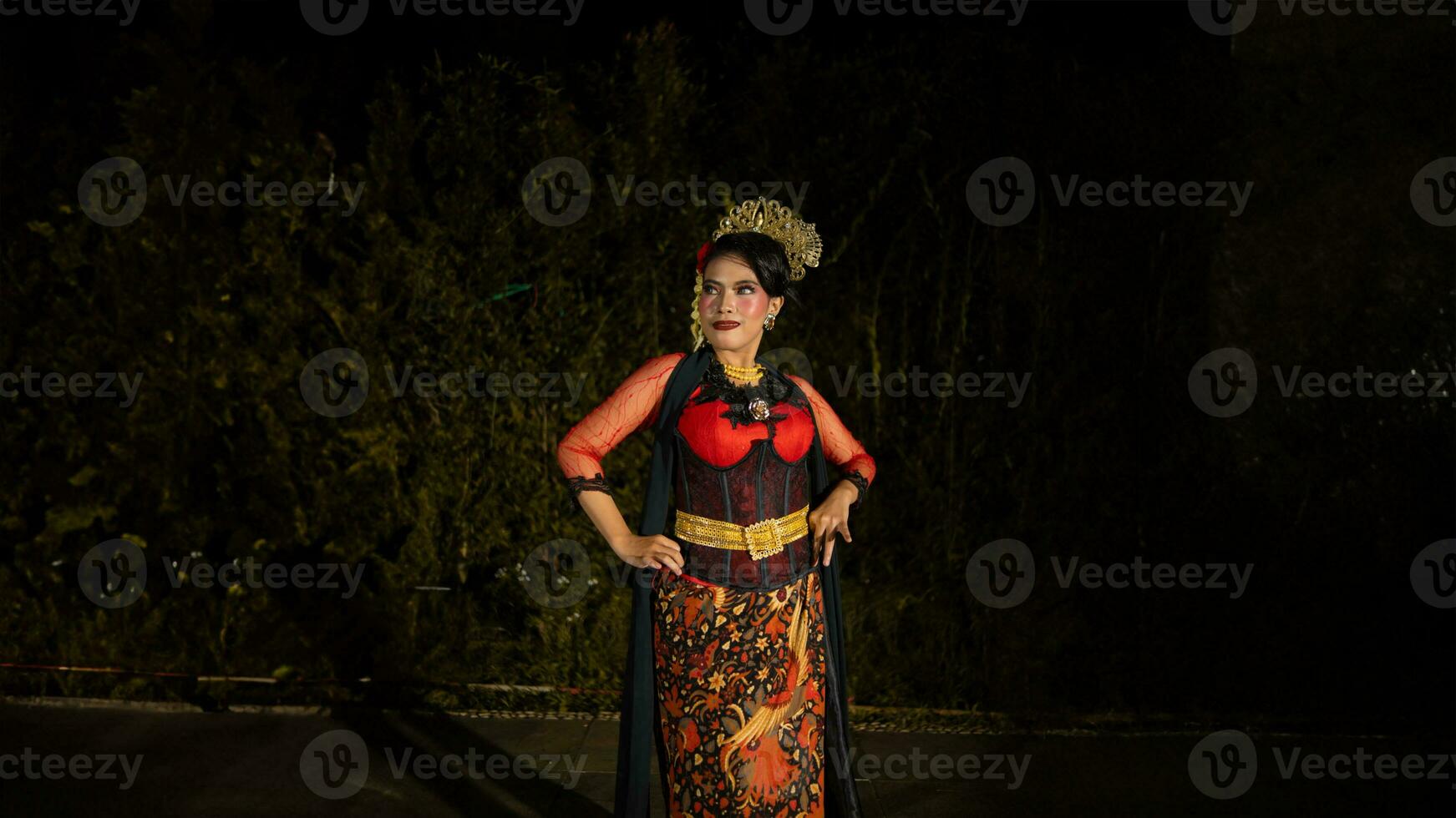 a Balinese dancer wearing a red dress with artistic details that add uniqueness to her appearance photo