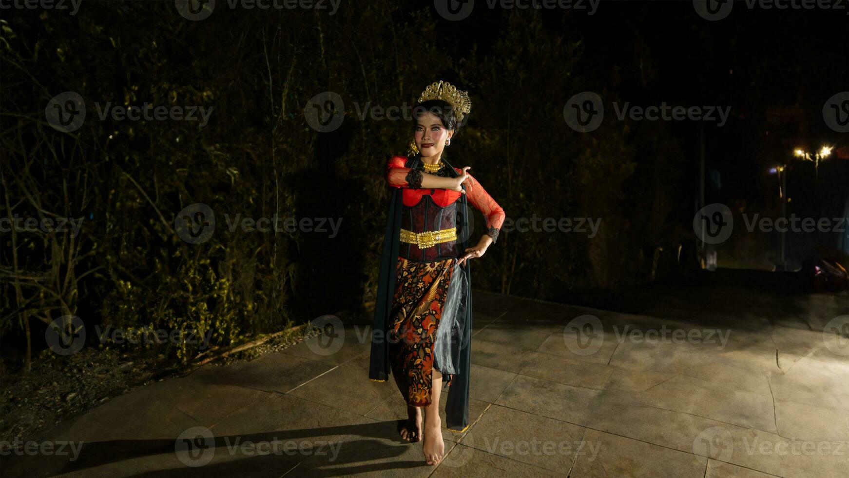 a Balinese dancer looks graceful when moving his hands and feet on stage very agilely photo