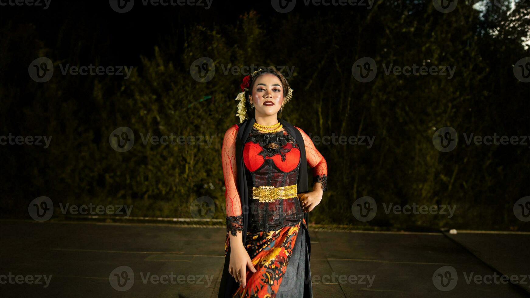 a Javanese dancer makes flexible and flowing movements in time with the rhythm of the music photo
