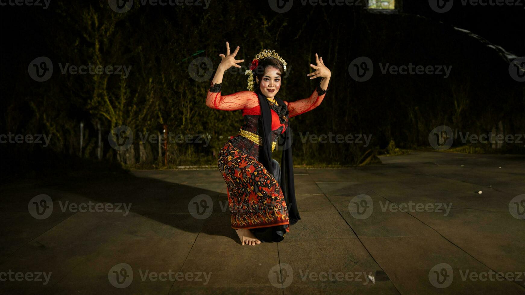 a Javanese dancer makes flexible and flowing movements in time with the rhythm of the music photo