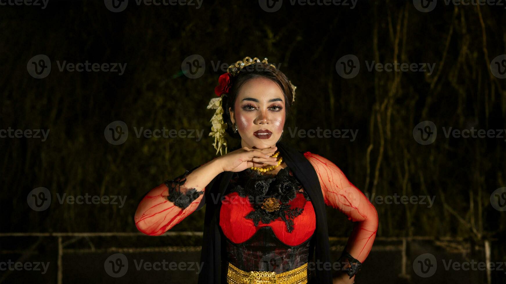 a female dancer in a red dress danced on stage, reflecting the beauty of her movements and adding to the charm of her performance photo